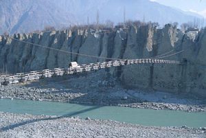 A narrow suspension bridge across the river Gilgit. It goes into a tunnel thatopens into Karkorum hills